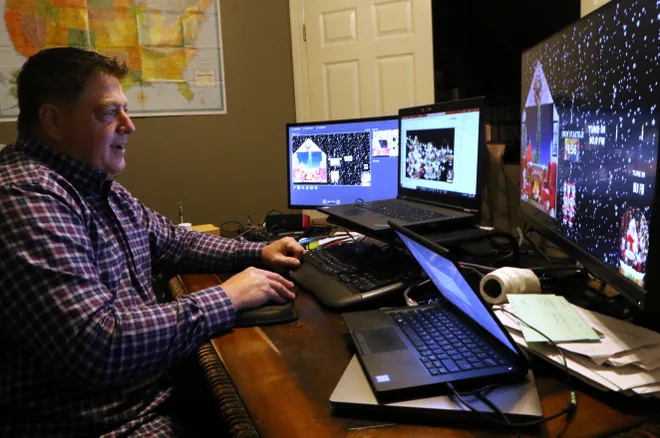Mark Galluccio working late at his home office, editing sports graphics across multiple screens